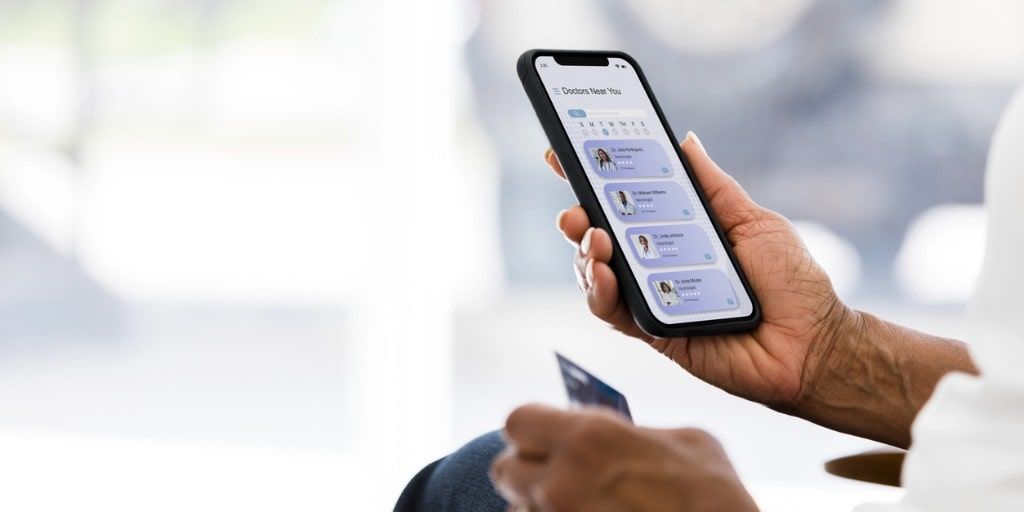 COG205 senior-woman-uses-credit-card-to-pay-for-telemedicine-appointment-picture-id1333401860-min